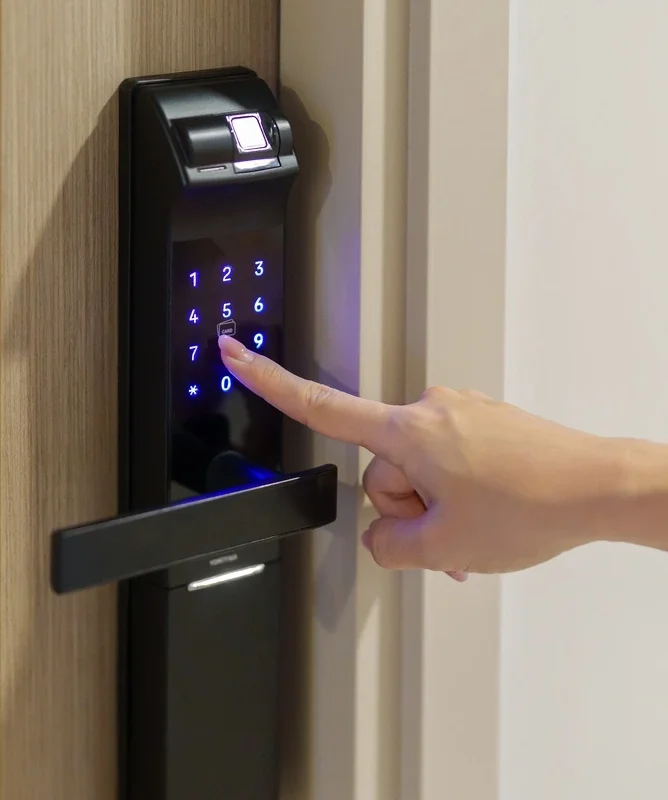 A person enters a secure pin into a modern digital smart lock installed by Rapid Locksmiths for enhanced home security